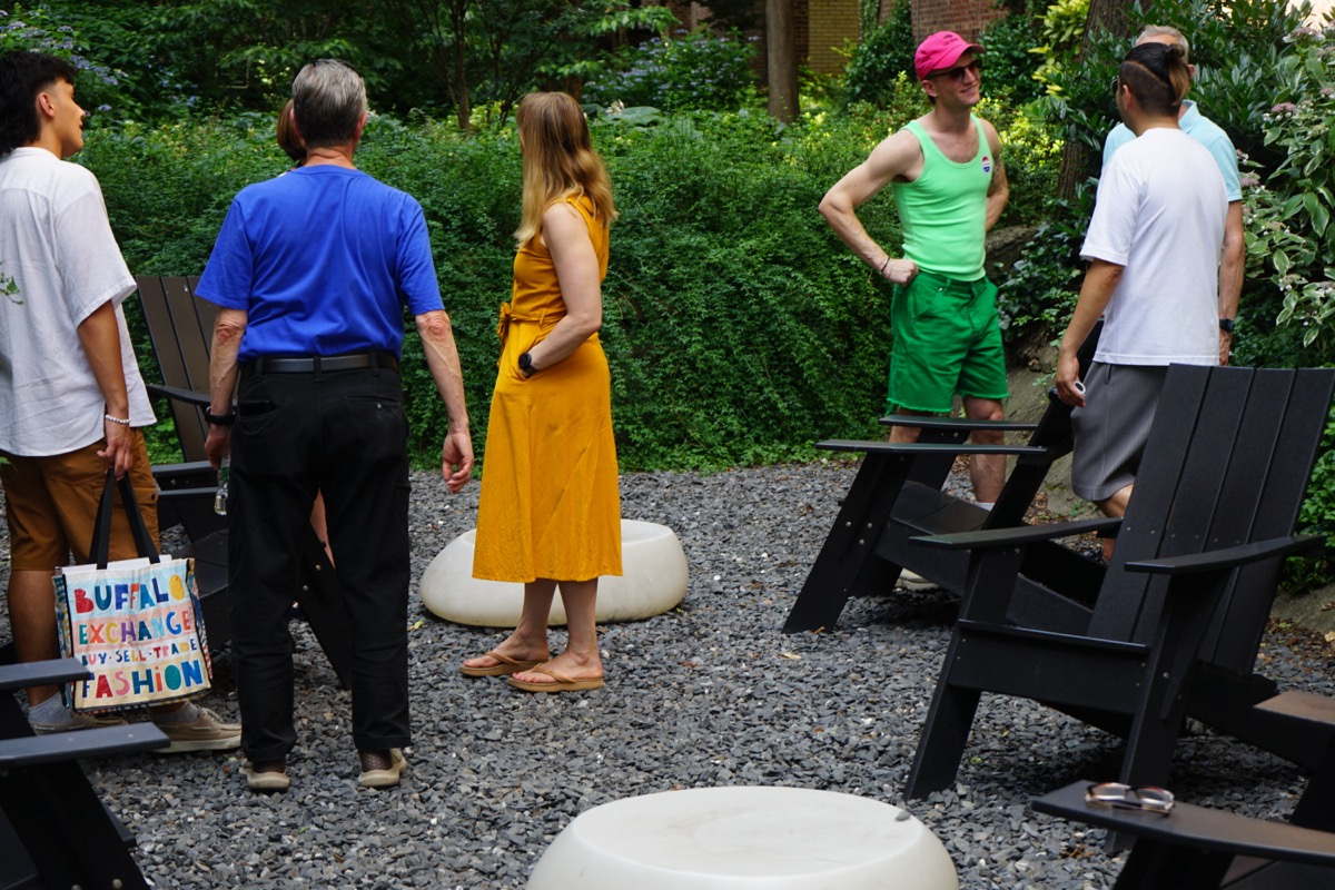 People talking in a Jackson Heights garden